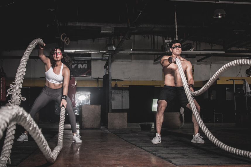 Man And Woman Holding Battle Ropes